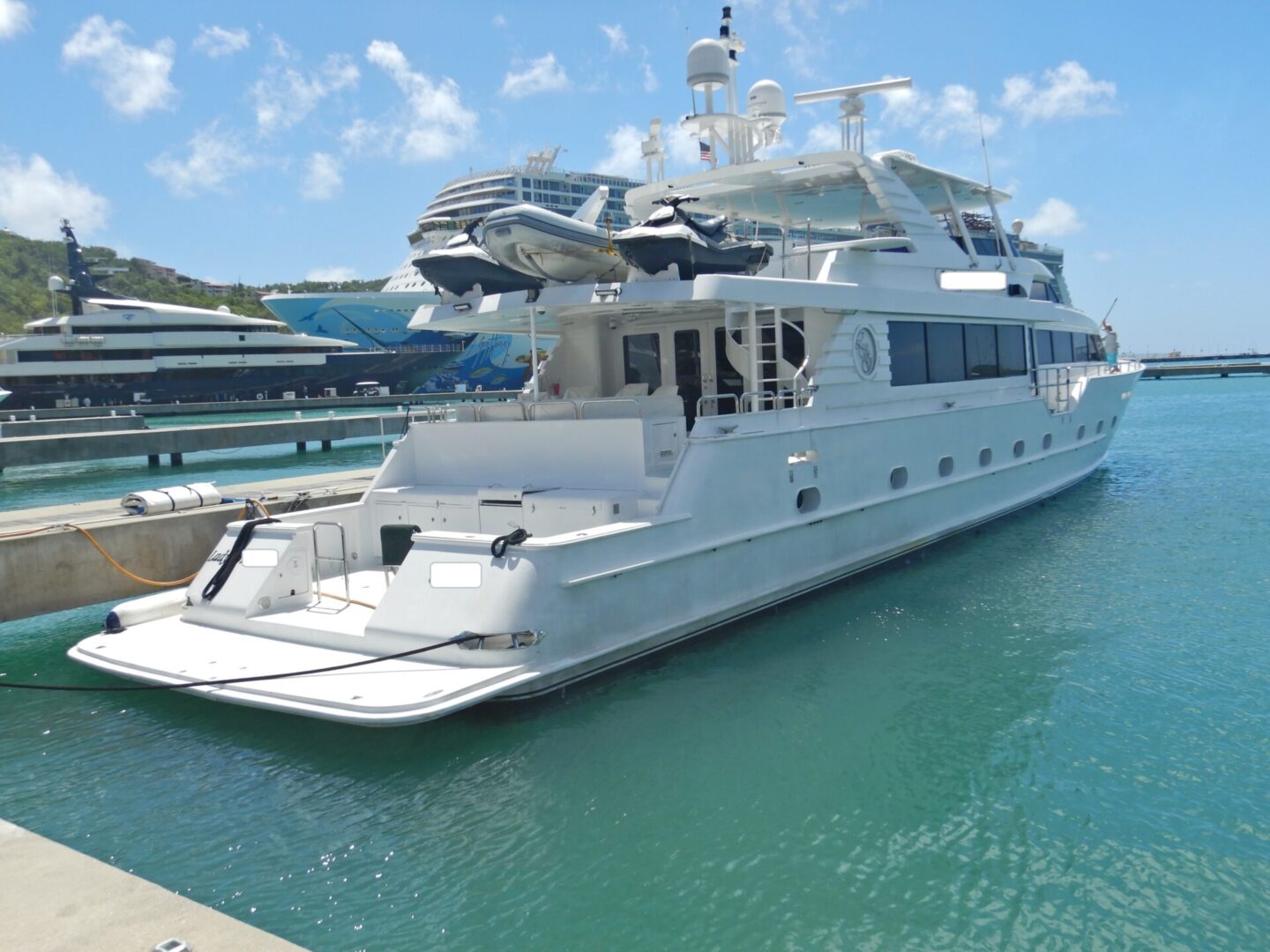 A large white boat docked at the dock.