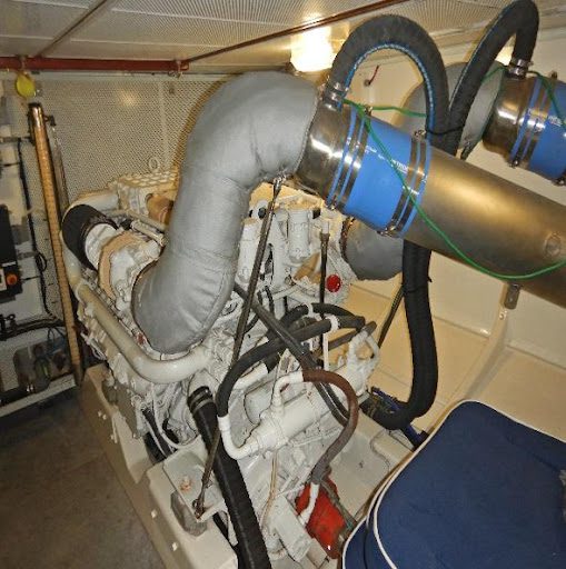 A boat engine with two pipes attached to it.