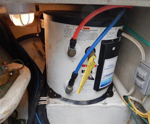 A water heater with wires connected to it.