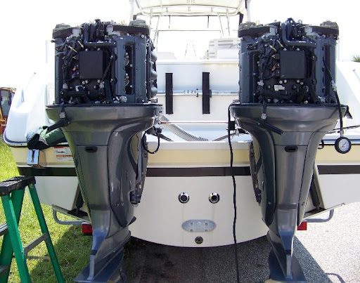 Two outboard motors are attached to a boat.