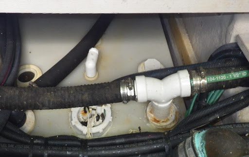 A close up of the pipes and hose on a boat